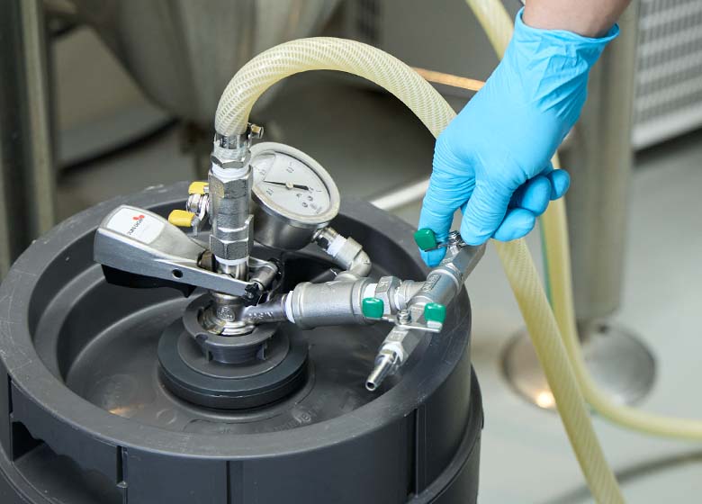 Filling the keg with beverage through the coupler